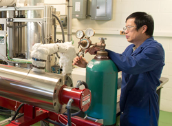Argonne National Laboratory mechanical engineer Wenhua Yu prepares to test a prototype thermal energy storage system.